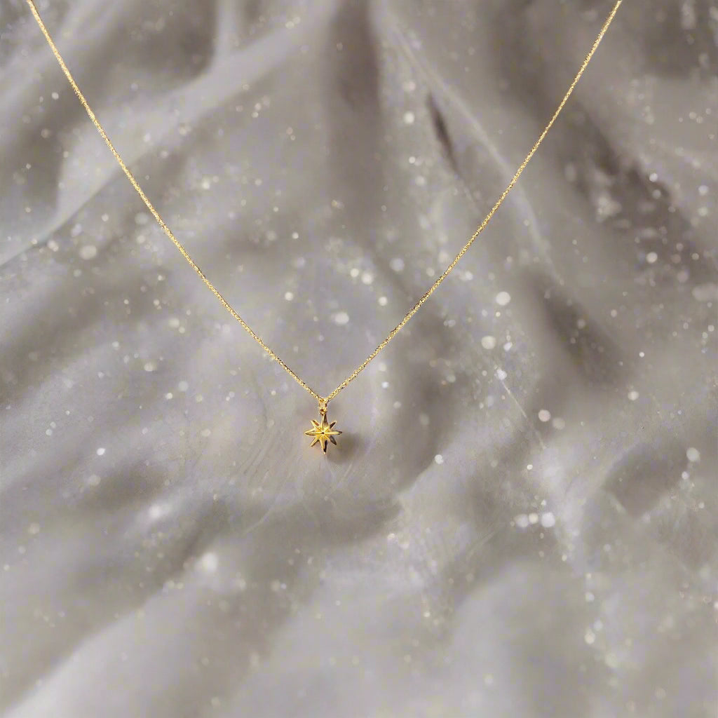 14K Gold North Star Charm Necklace, our eight-point North Star Charm Necklace has a tiny gold 8 point star charm on 14k gold-filled chain, it's a charming 