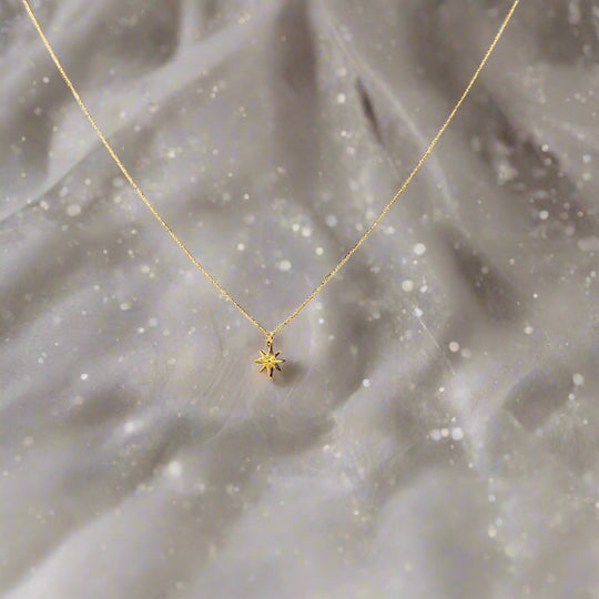 14K Gold North Star Charm Necklace, our eight-point North Star Charm Necklace has a tiny gold 8 point star charm on 14k gold-filled chain, it's a charming 