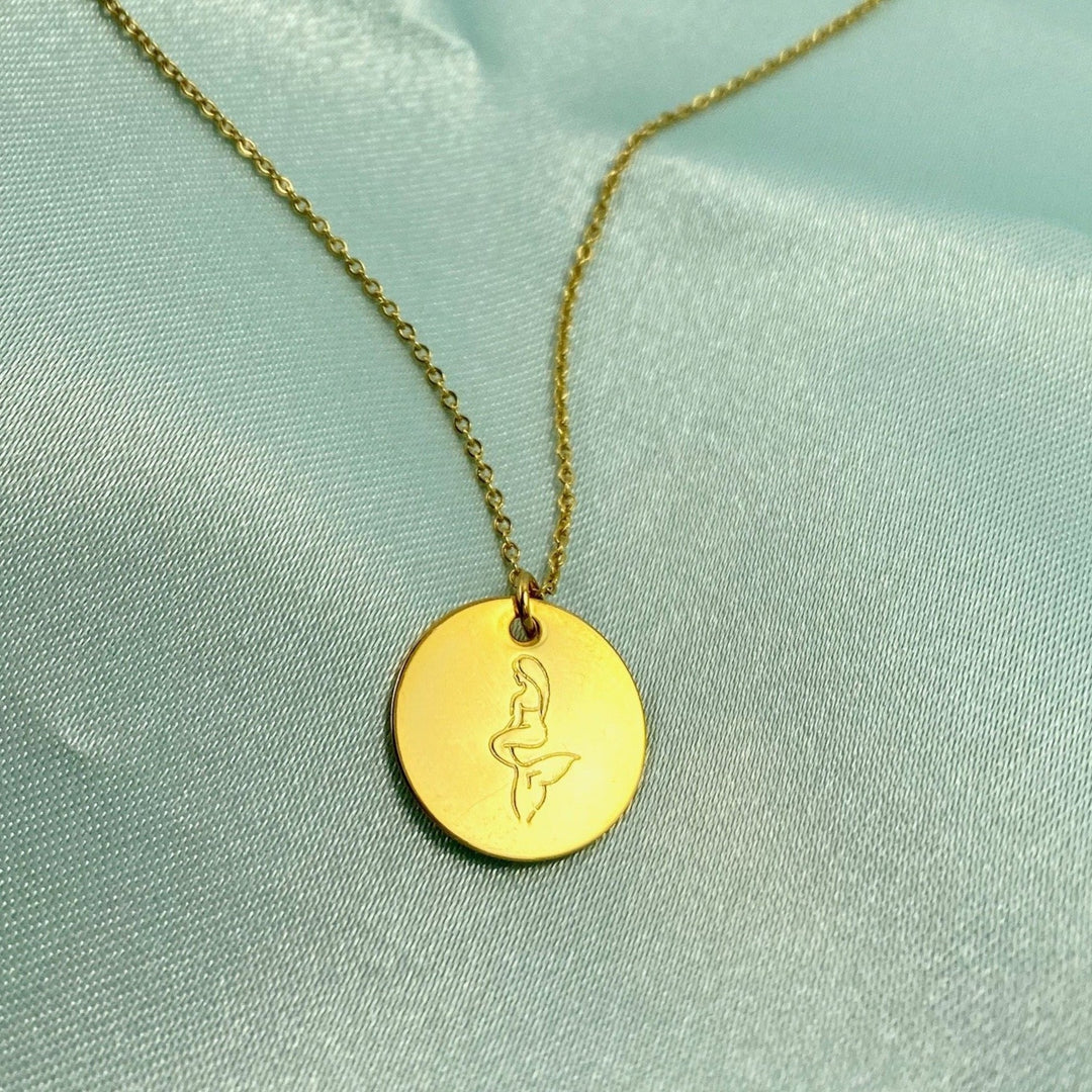 Gold Hand Stamped Mermaid Necklace, our tiny sweet mermaid is hand stamped on a gold disk with a 14k gold filled chain, it's adoring charm makes an endless treasure.